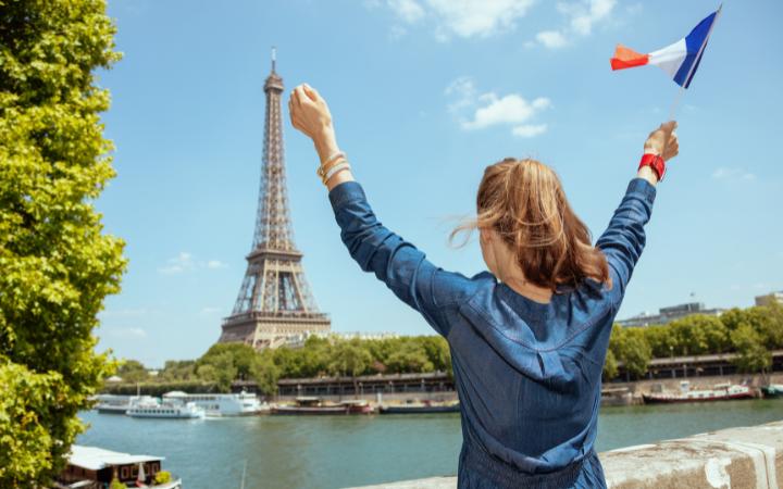 A professional woman reviewing visa documents at a Paris café — France work visa guide